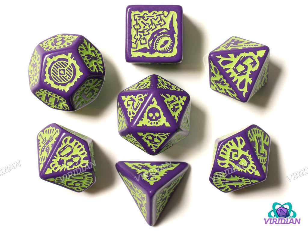 Pathfinder: Goblin polyhedral dice set featuring 7 ornate acrylic dice in green and purple with goblin-themed engravings for tabletop RPGs.