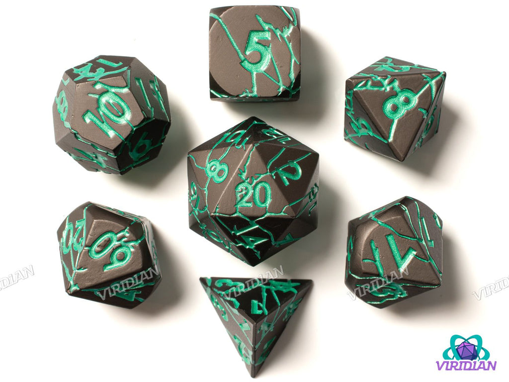 Colossus of Rhodes polyhedral metal dice set in cracked gold bronze with teal green numbering, ideal for tabletop RPGs and DnD campaigns.