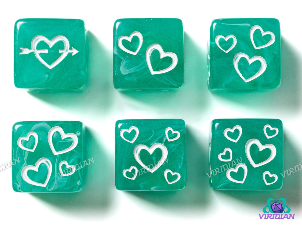 Green Heart D6s (Set of 6) translucent resin dice with white heart designs and swirls, ideal for tabletop games and collectors.