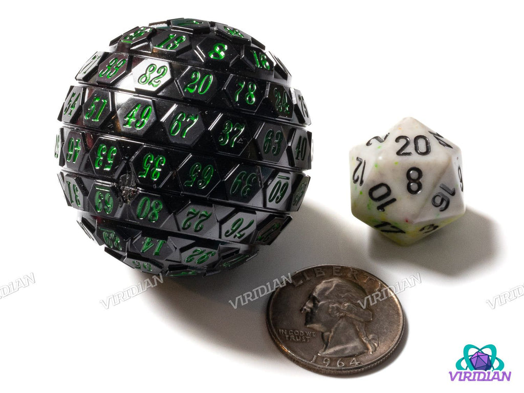 Giant 45mm Black & Green D100 percentile die with green numbering, displayed beside a D20 and quarter to highlight scale for tabletop gaming.