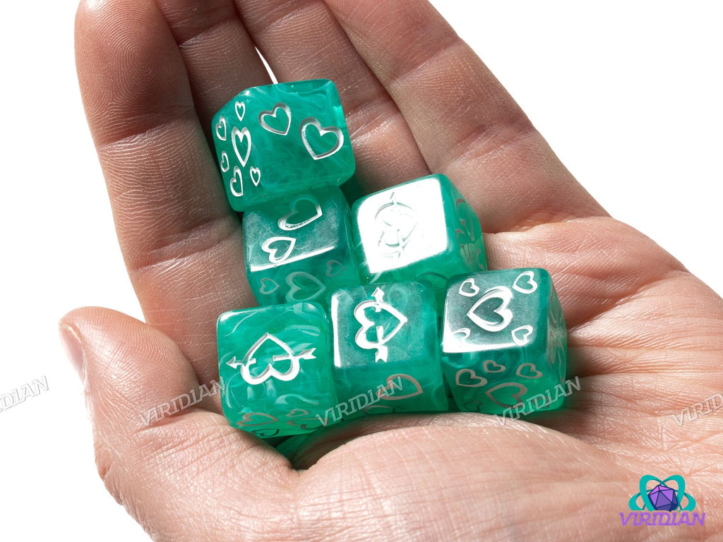 Green Heart D6s (Set of 6) displayed in a hand, showcasing their compact size, white inked heart symbols, and vibrant green swirled design.