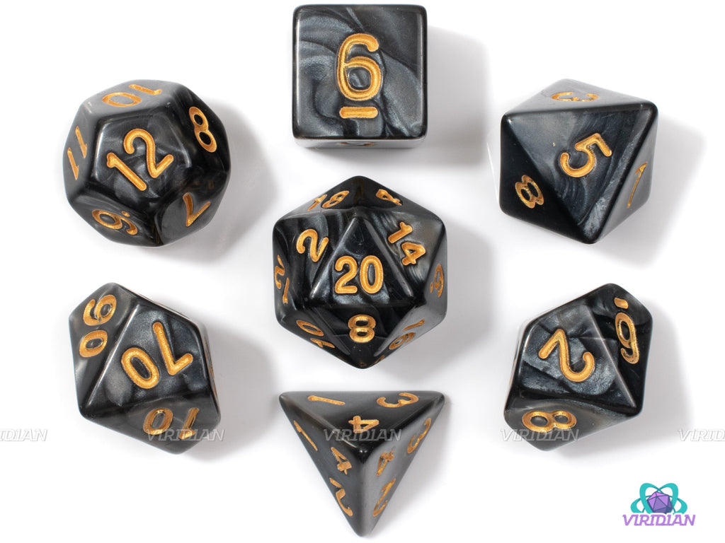 Black acrylic DnD dice set featuring seven polyhedral gaming dice with gold numbers